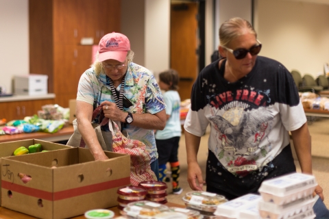 Classified employees attend a food distribution event.